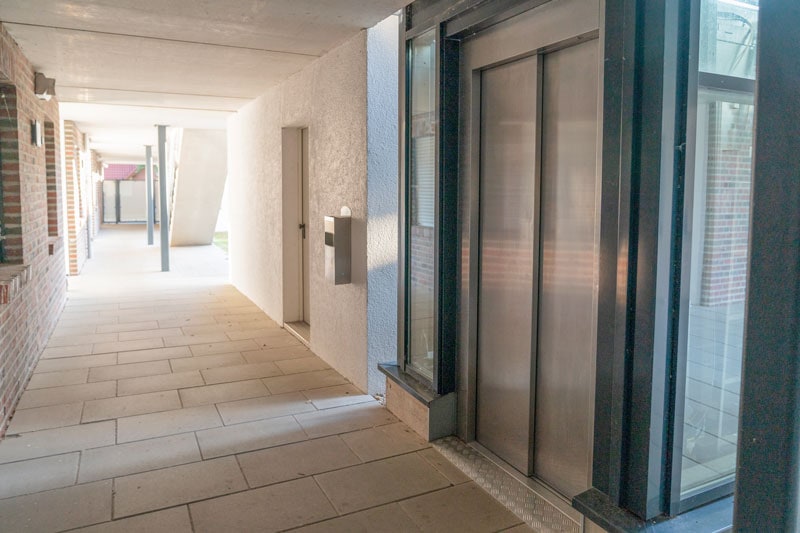 Moderner aufzug in einem wohngebäude, barrierefreier zugang, hochwertiges design, energieeffizienz, komfortabler service, wohnkomfort, barrierefreiheit, wohnungsauflösung, umweltfreundlich, nachhaltiges wohnen.